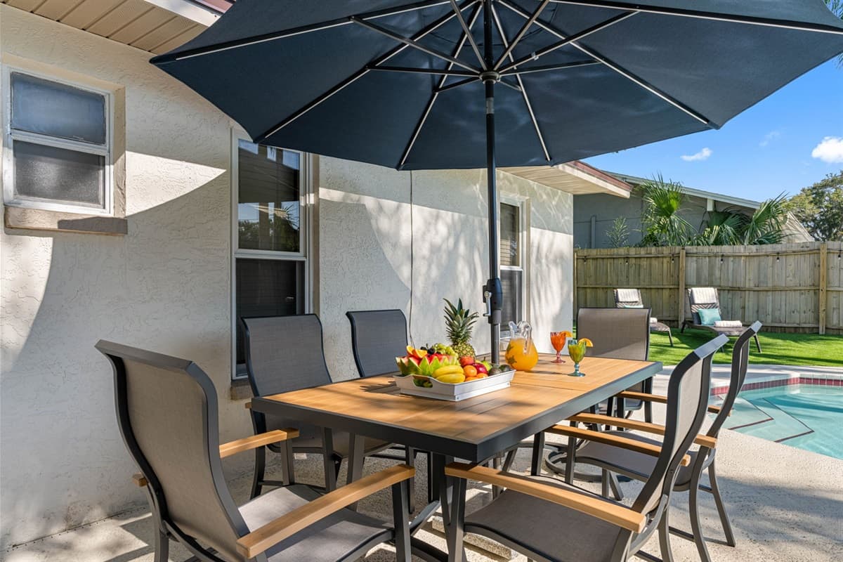 Imagine stepping into your private oasis, where the outdoor dining space beckons with the promise of relaxation and enjoyment.