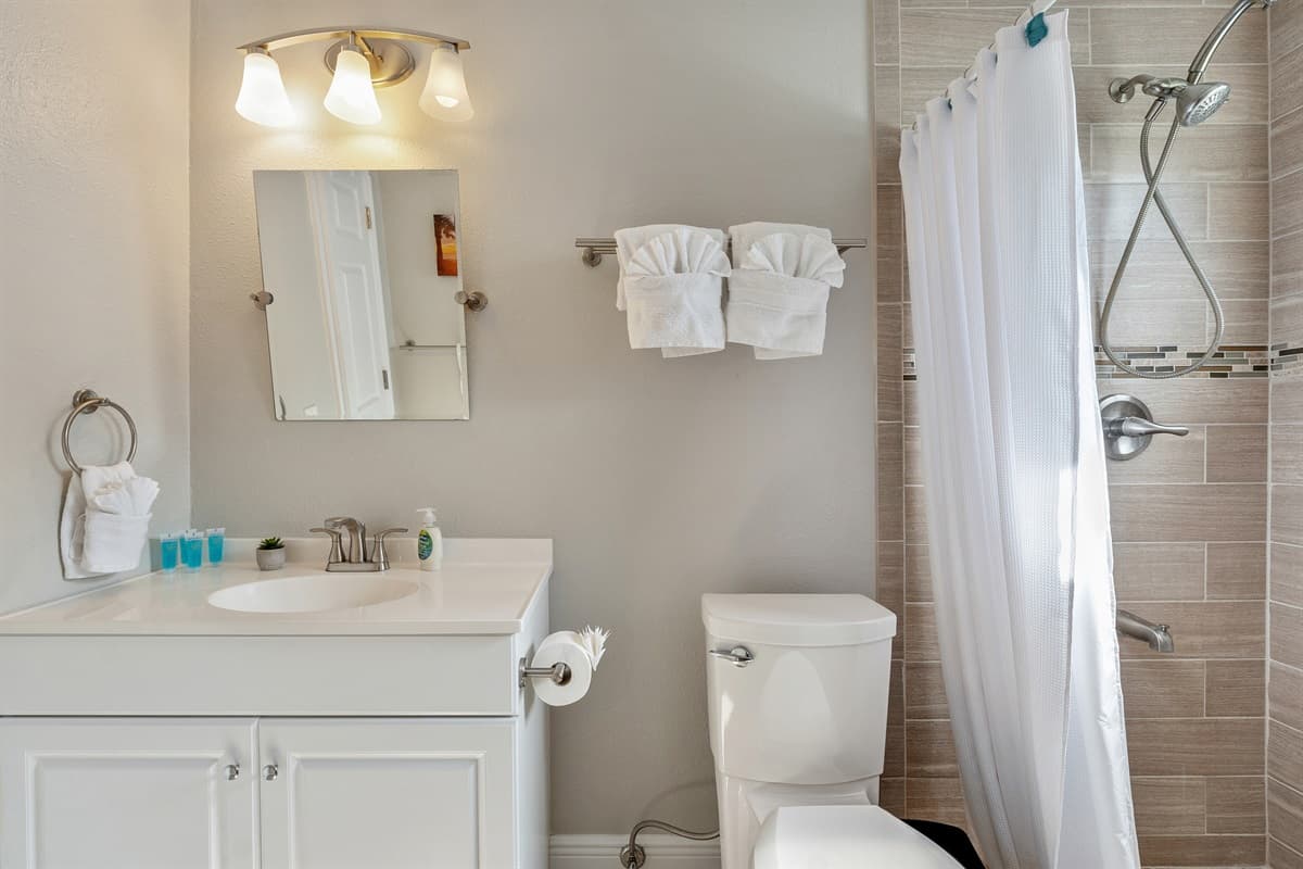 The bathroom features a harmonious blend of functionality and style, boasting contemporary fixtures and tasteful decor.