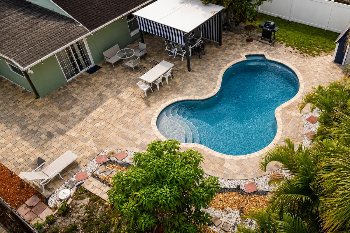 Stunning aerial perspective of the pool and outdoor living areas designed for relaxation and family fun.