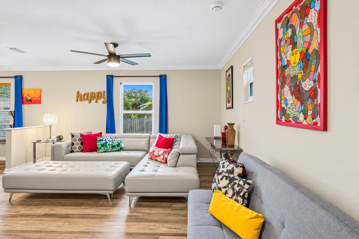 Alternate view of the living space highlighting natural light, modern decor, and roomy layout.