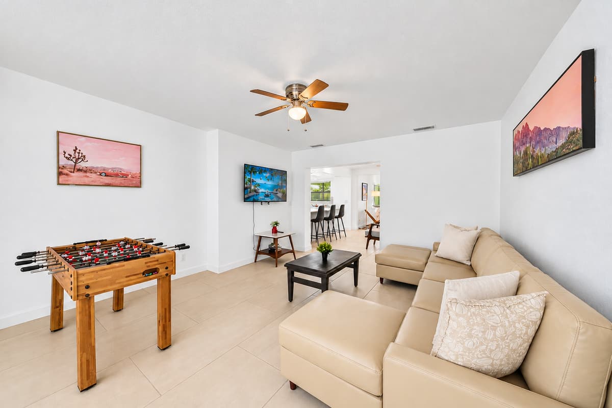 Fun-filled entertainment area featuring foosball table, spacious seating, and modern décor.