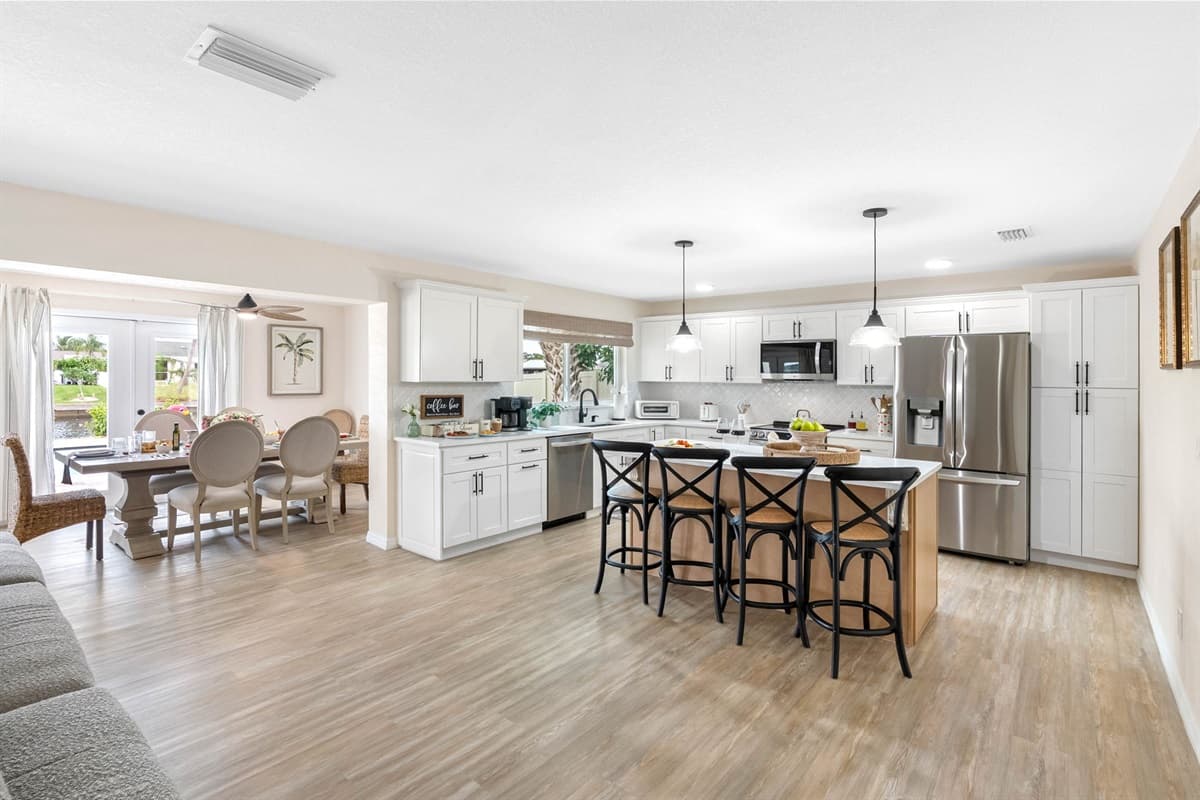 Cook with ease in this fully stocked kitchen, complete with stainless steel appliances, ample counter space, and a stylish breakfast bar.