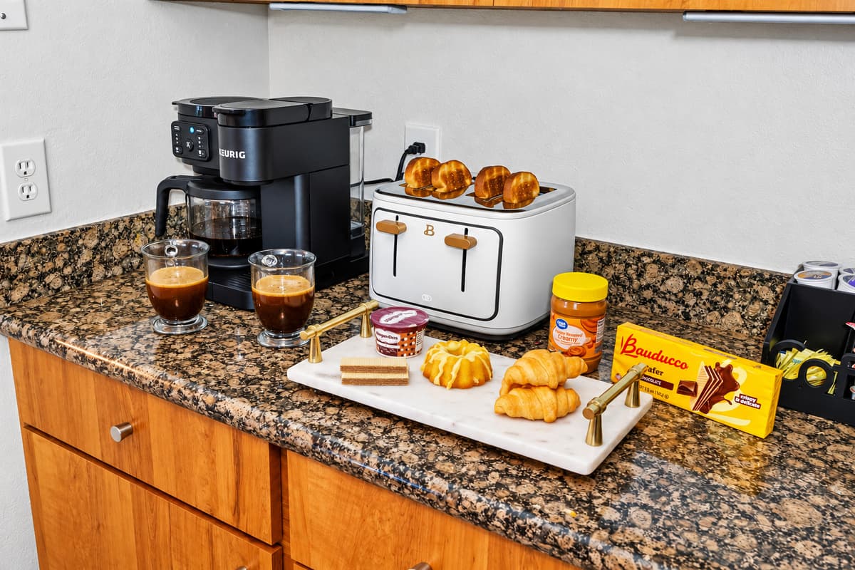This fully equipped kitchen features gleaming granite countertops, warm wood cabinetry, and modern stainless steel appliances—making it as functional as it is inviting for your inner chef.