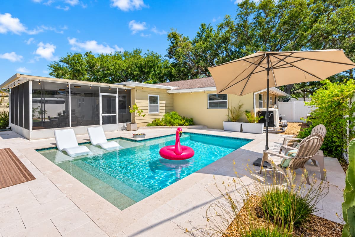 Dive into the turquoise waters of your heated pool, surrounded by privacy fencing and tropical plants.