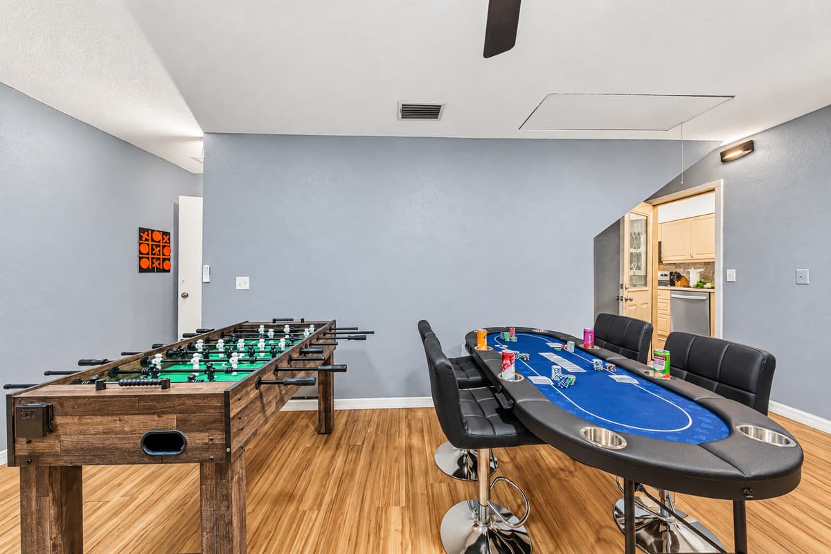 Large entertainment room featuring foosball and poker table—perfect for game nights with your group 