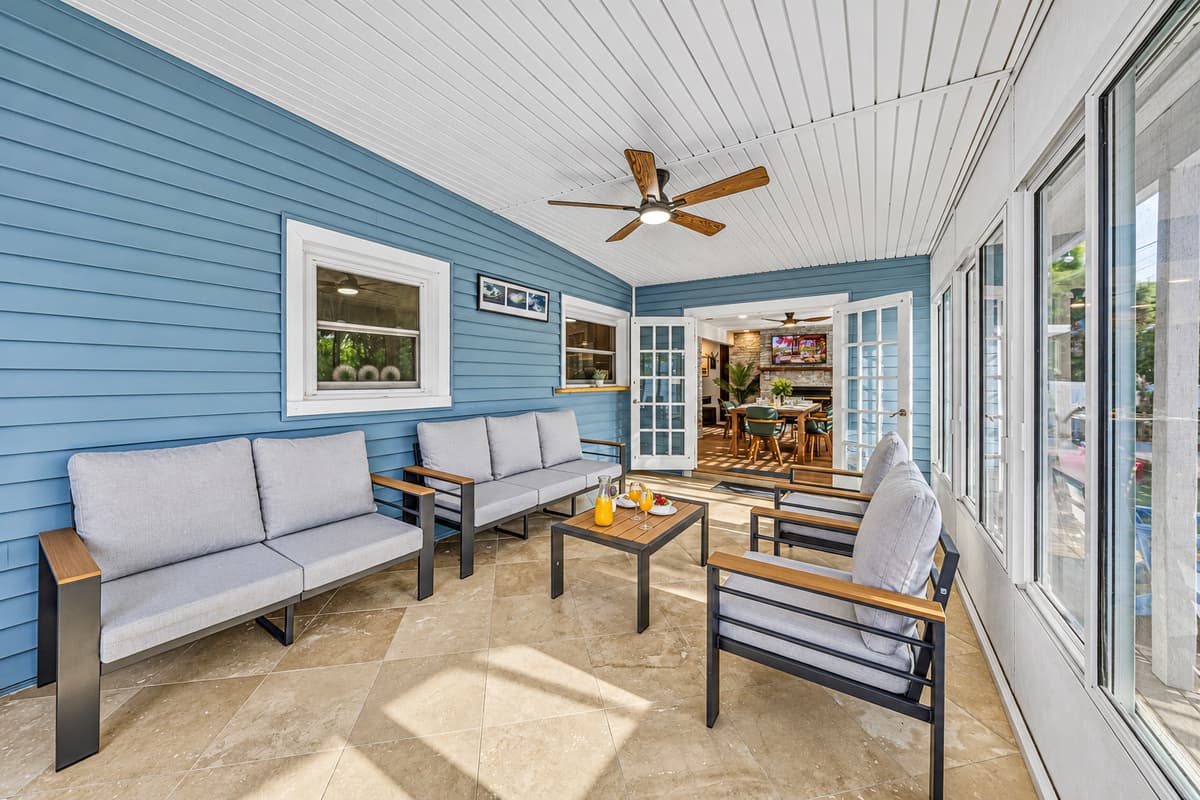 Beautiful screened-in patio with comfortable seating and ceiling fan—great for year-round enjoyment 