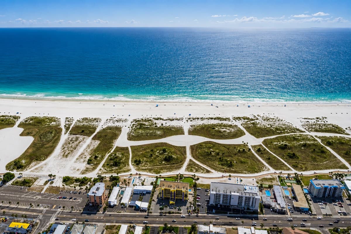 Top-down aerial view of the waterfront neighborhood with canal access and nearby homes.