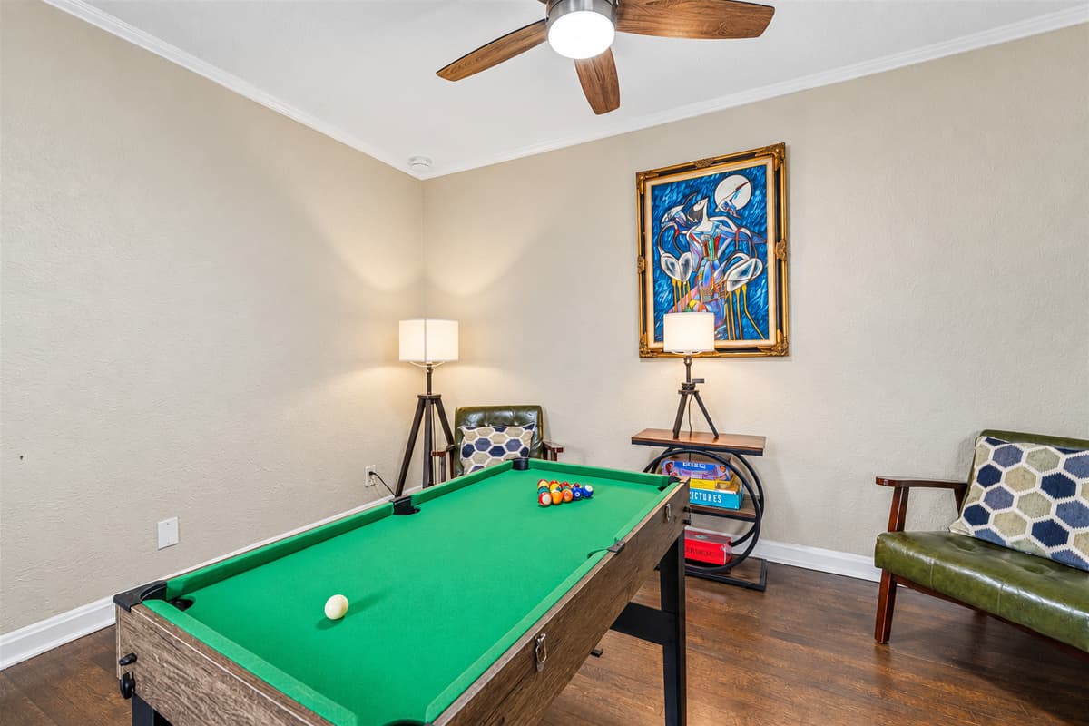 Dedicated game room with pool table and cozy seating for fun, entertainment, and friendly competition.