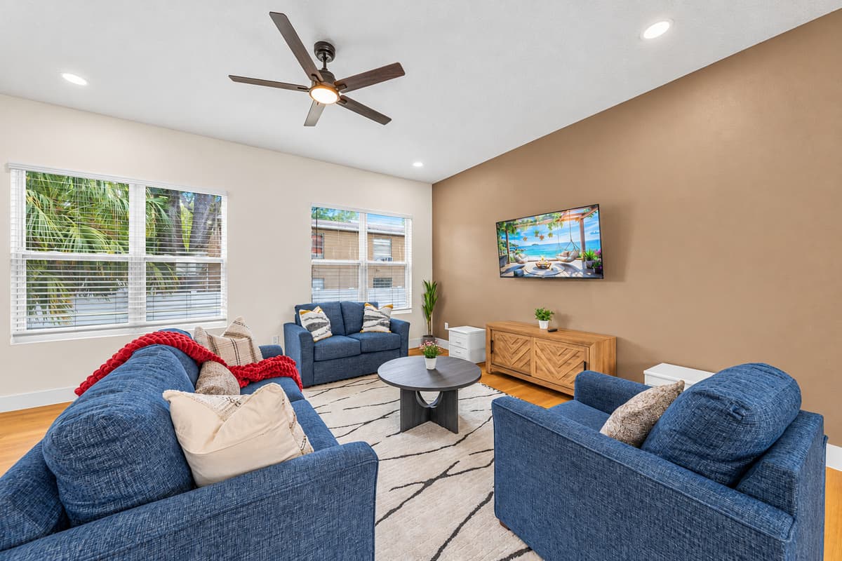 Comfortable living room with plush seating, natural light, and entertainment setup.