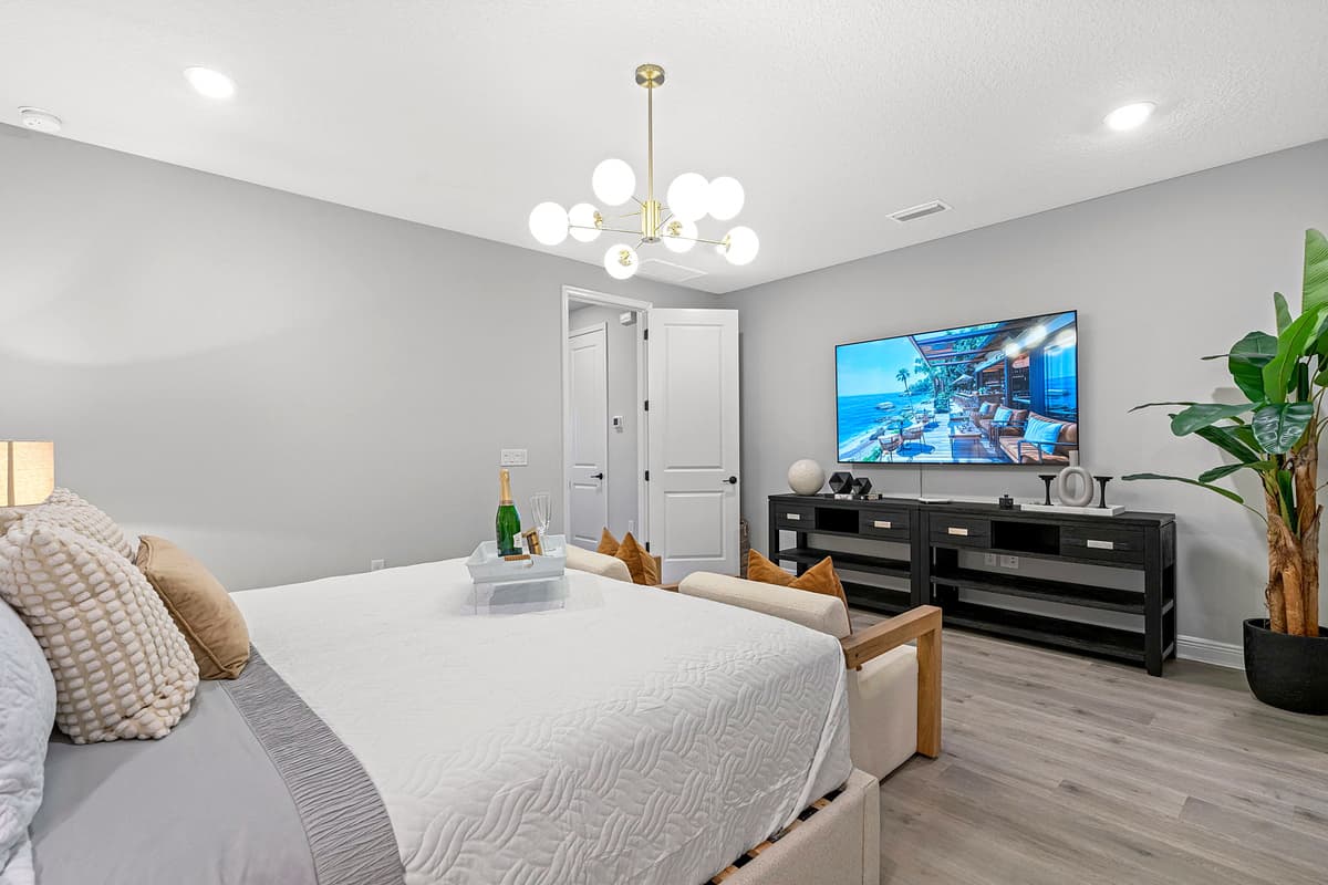 At the center of the room stands a luxurious king-sized bed, its plush mattress and sumptuous linens promising a night of unparalleled comfort.