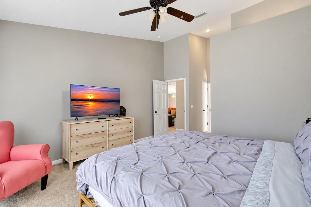 This stunning bedroom features a king sized bed and with its expansive windows not only flood the room with natural light but also offer panoramic views of the surroundings.