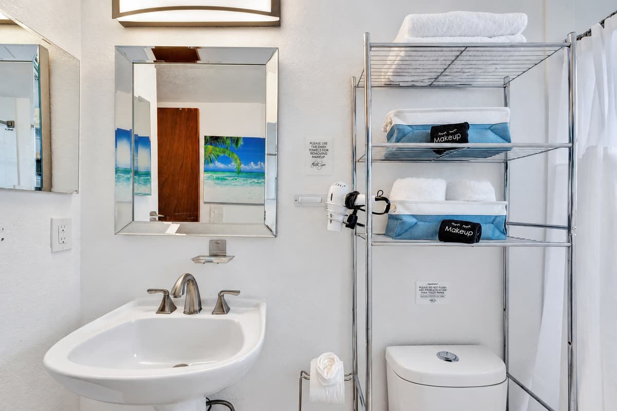 The sleek design of the vanity is complemented by a large, well-lit mirror, ensuring you have perfect lighting for your morning and evening routines.