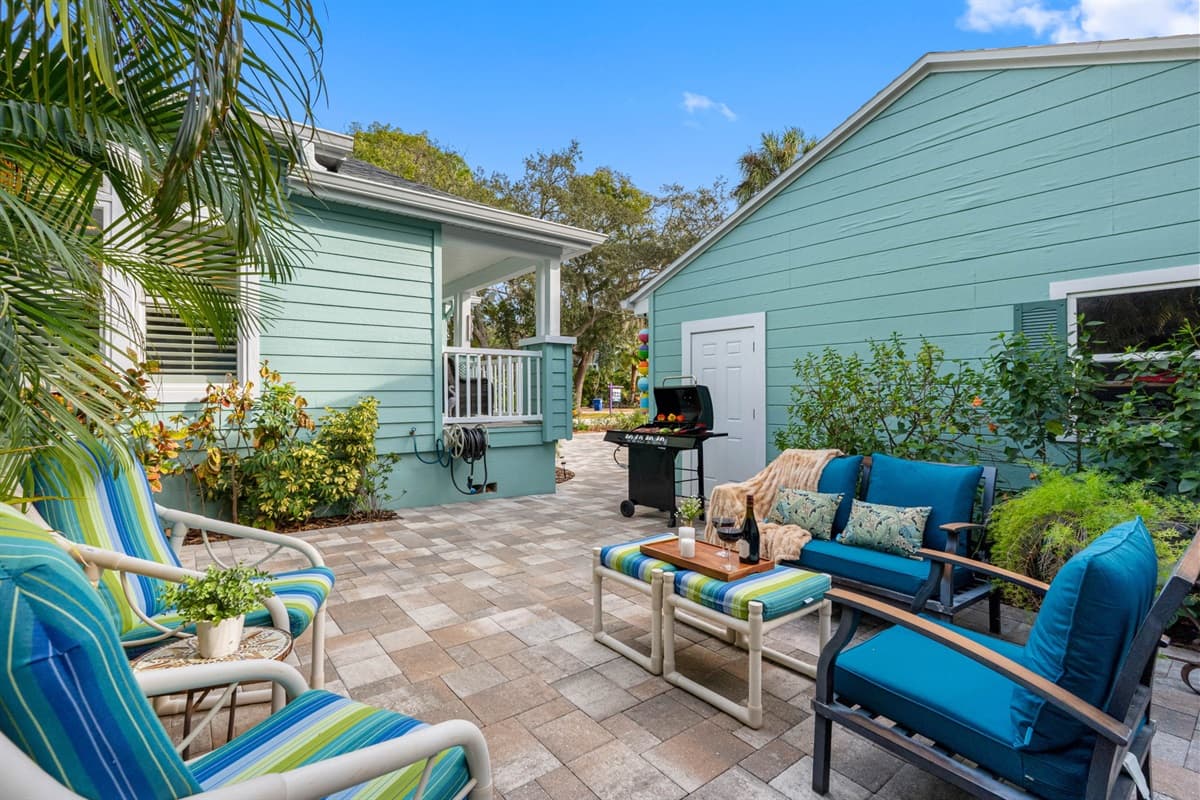 Tucked beside beautiful palms, this outdoor seating nook provides a peaceful retreat with natural privacy.