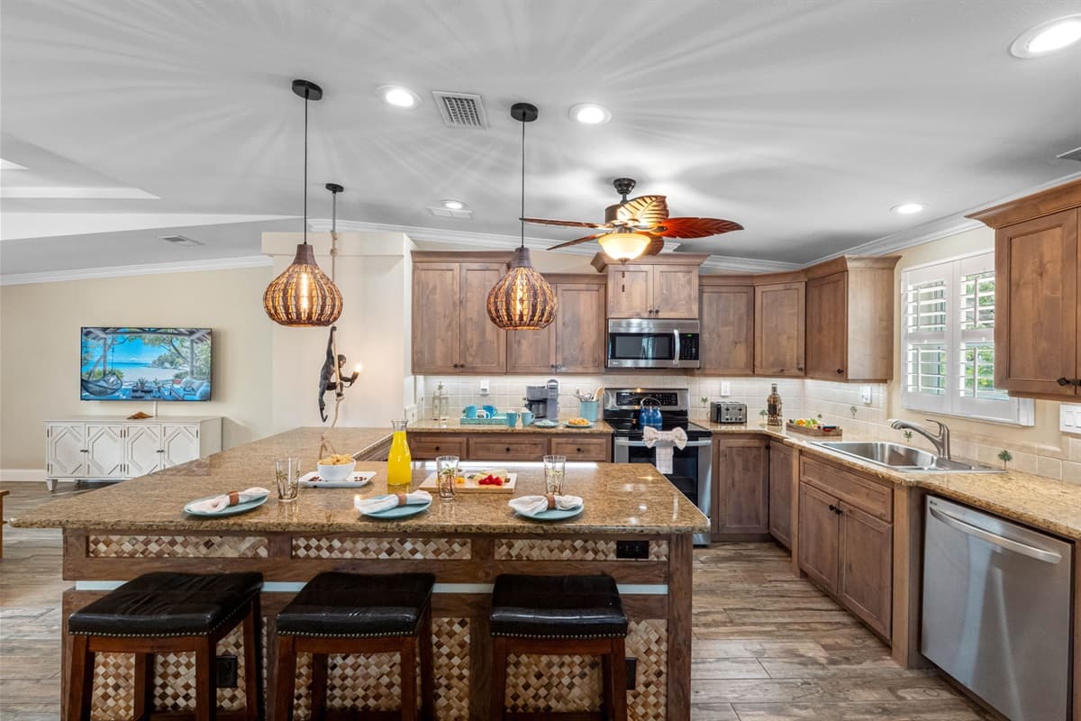 Warm wood tones and elegant lighting make this kitchen feel cozy yet luxurious, offering everything needed for a comfortable stay.
