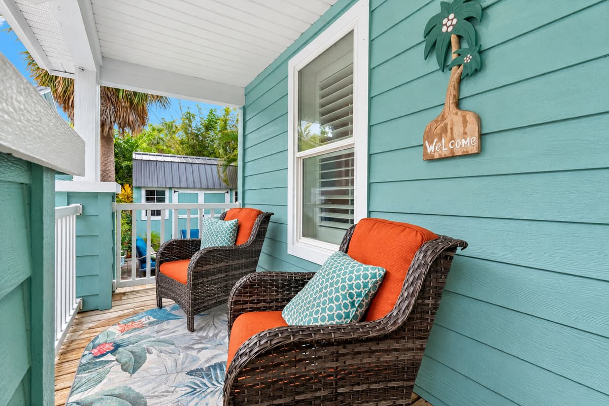 The inviting front porch features a cozy seating area perfect for enjoying your morning coffee.