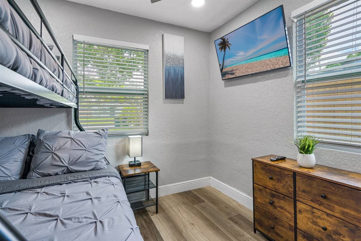 This beautiful room has a single over twin bunkbed, full length mirror closet and drawers for storage, and its own smart TV! 