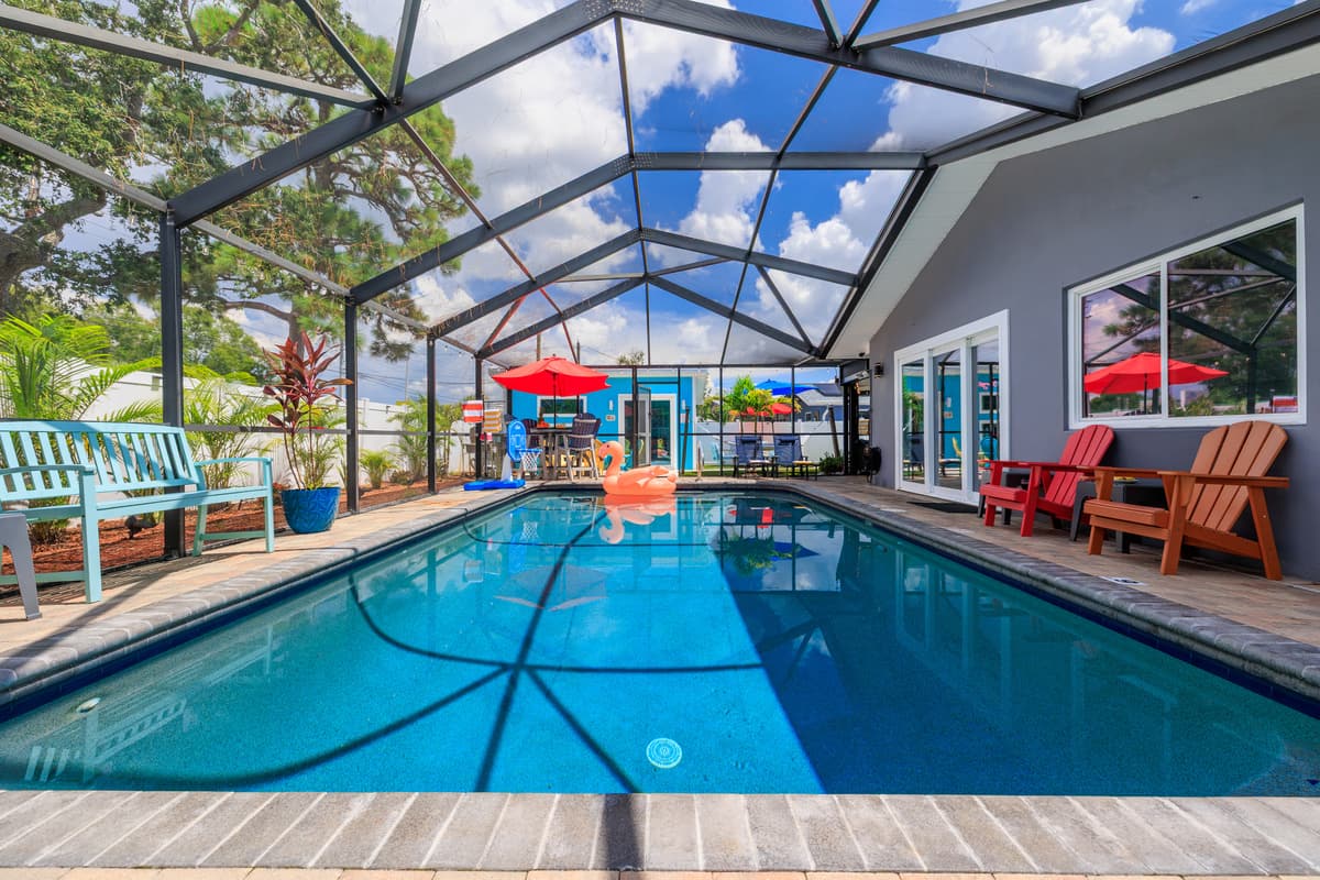 Screened-in pool and outdoor lounge space.