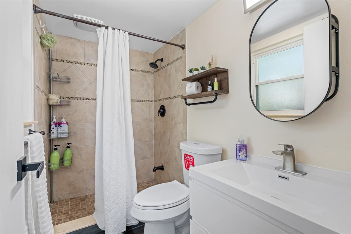 As you step into this stunning bathroom, you're immediately struck by the sleek and modern design. 