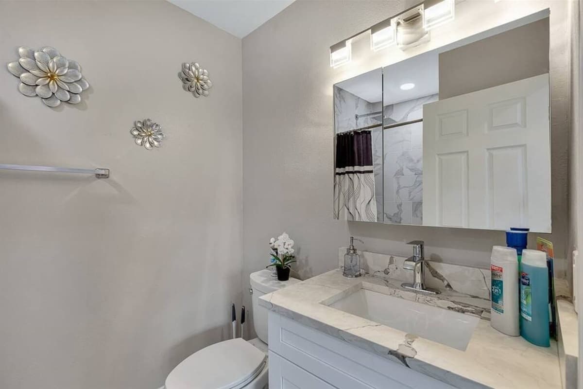 Beautiful bathroom with sink, toilet, and walk-in shower.  Enjoy a relaxing bath after a long day of travel from your home to your home away from home. If you like this property, send us a message now!