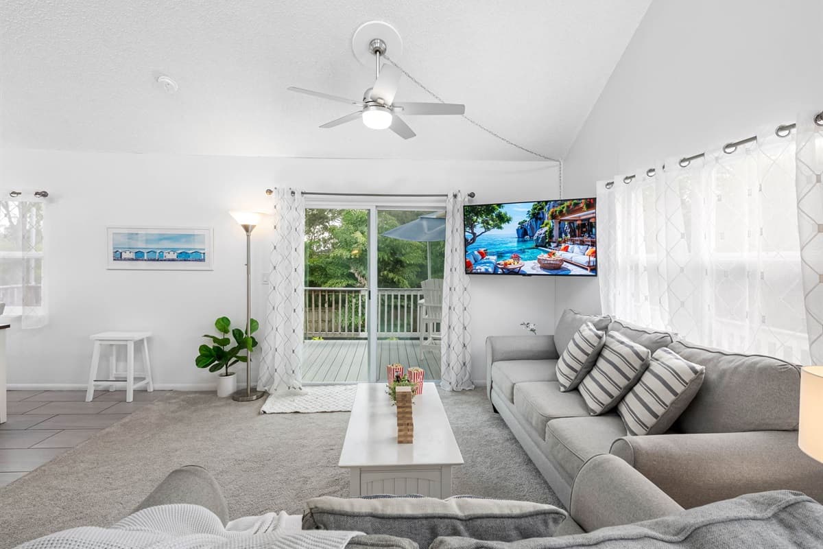 Natural light pours through the large windows, filling this open living room with warmth and creating a perfect space to relax with family and friends.