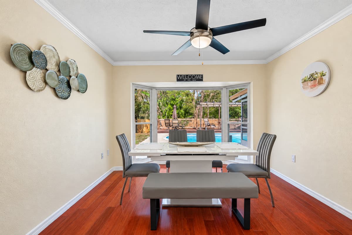 The sleek and minimalist dining table, surrounded by comfortable chairs, invites you to gather around and indulge in a delicious meal with your loved ones.