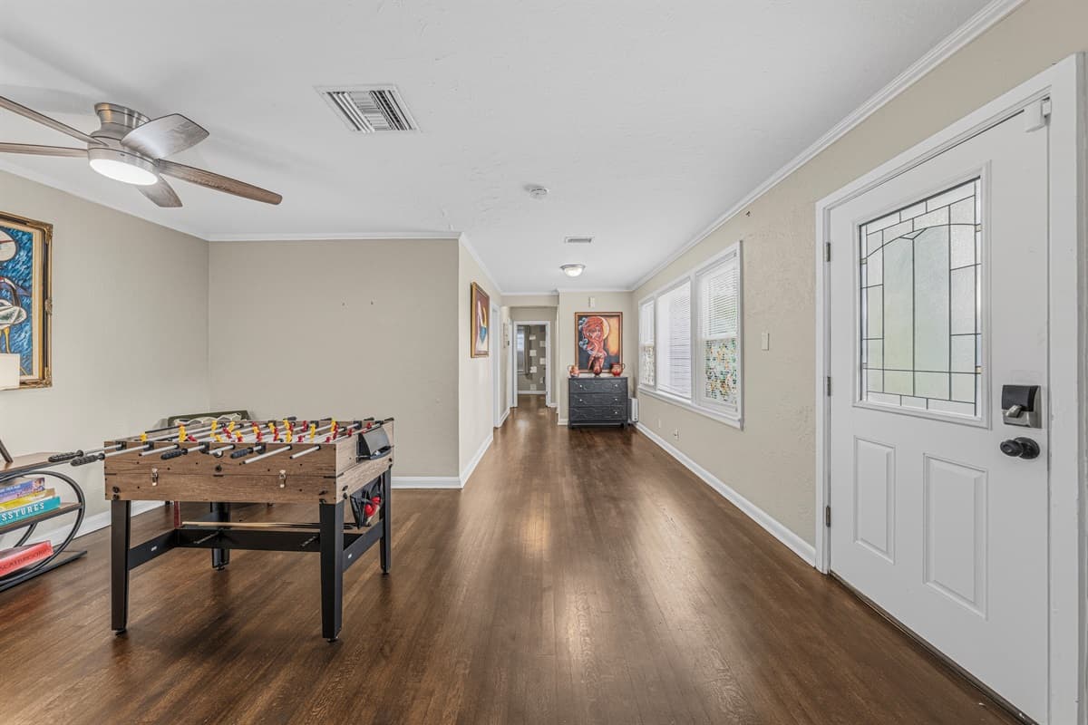 Long entertainment space with foosball table and plenty of room to relax or play.