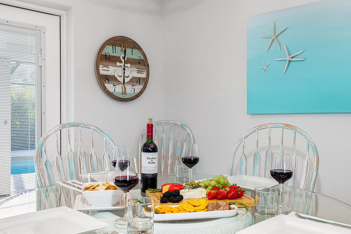 Positioned under a stylish light fixture, this space creates an inviting atmosphere for shared meals and meaningful conversations.