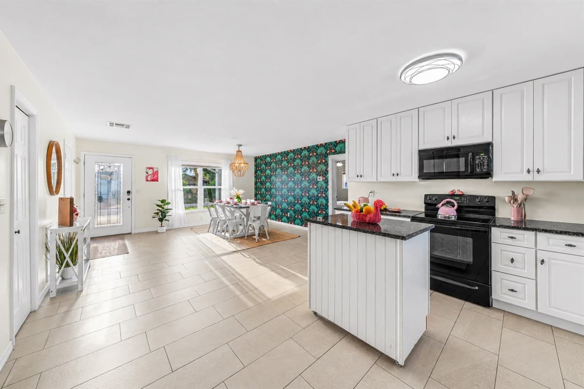 Bright, spacious kitchen with large island and open layout—perfect for cooking and gathering.