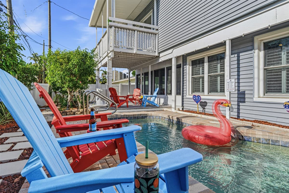 Private pool area with vibrant seating and a fun flamingo float—your own tropical retreat 