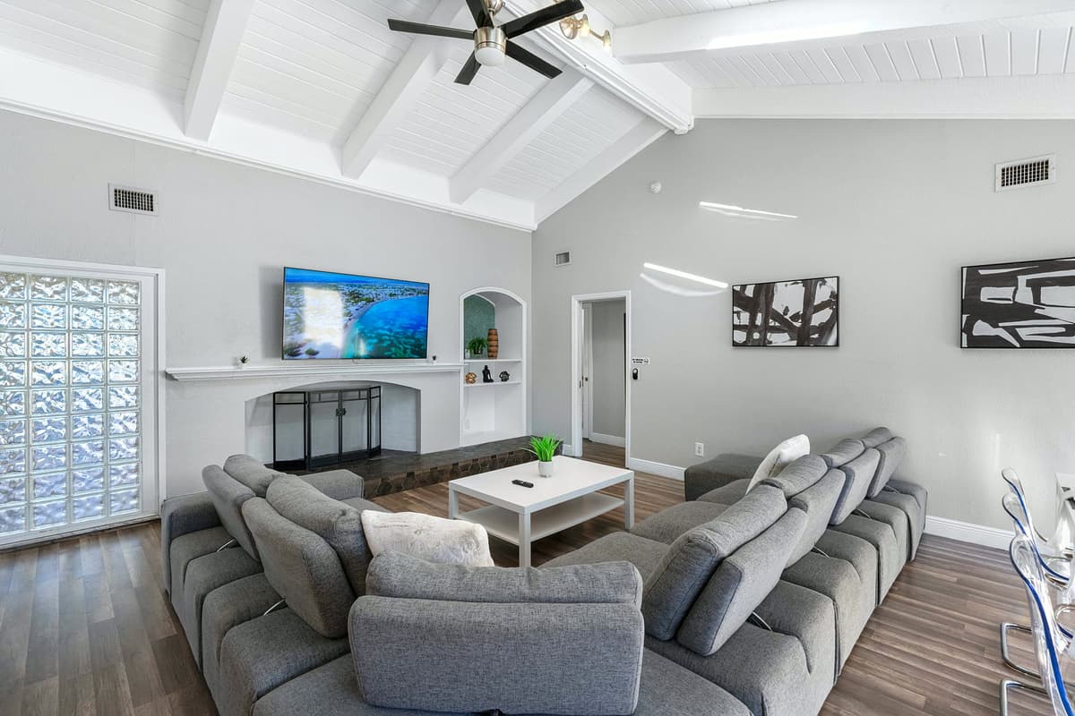 Cozy up on the oversized sofa and enjoy your favorite shows on the large flat-screen TV in this inviting, open-concept living room.