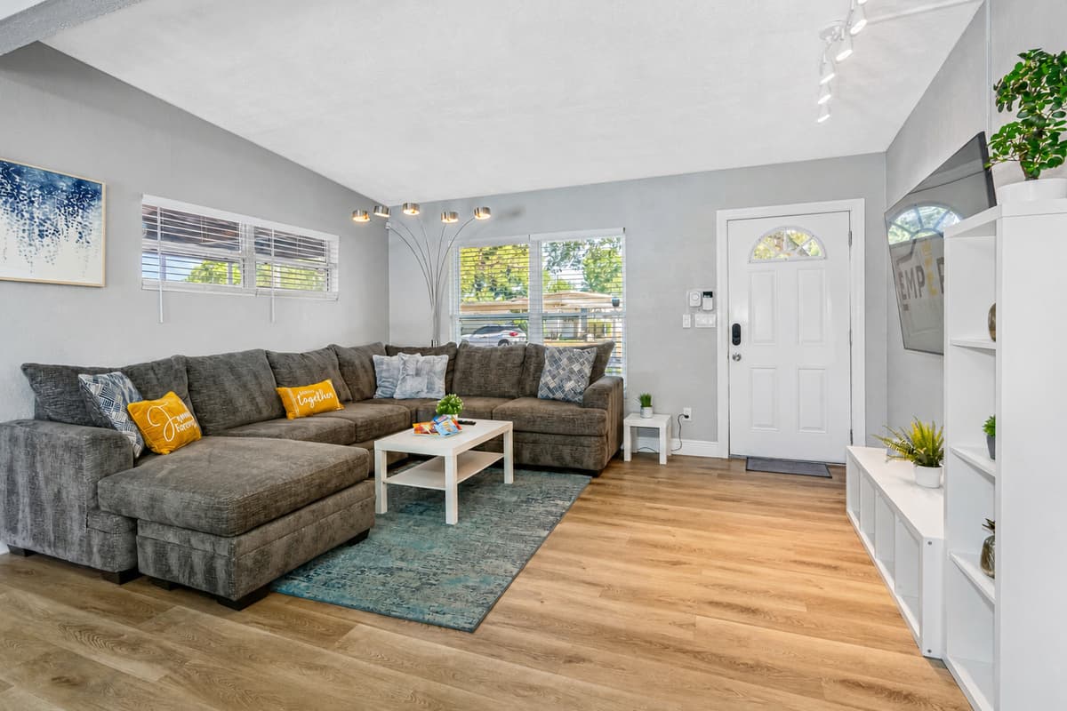 In front of the couch, there is a sleek white coffee table, which adds a touch of sophistication to the room.