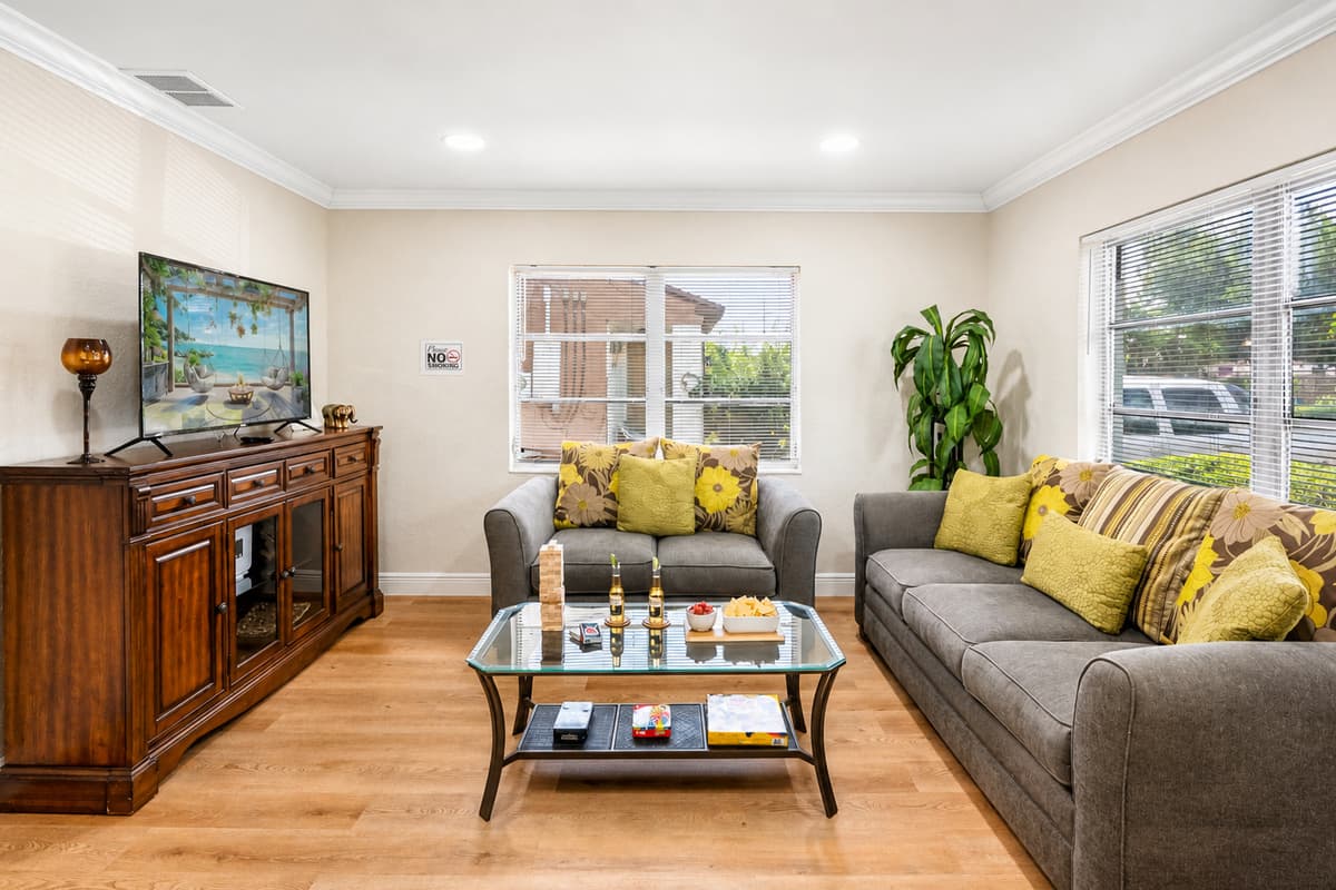 The neutral tones not only add to the calming ambiance but also complement the room’s natural light, which pours in through well-placed windows and brightens the entire space throughout the day.