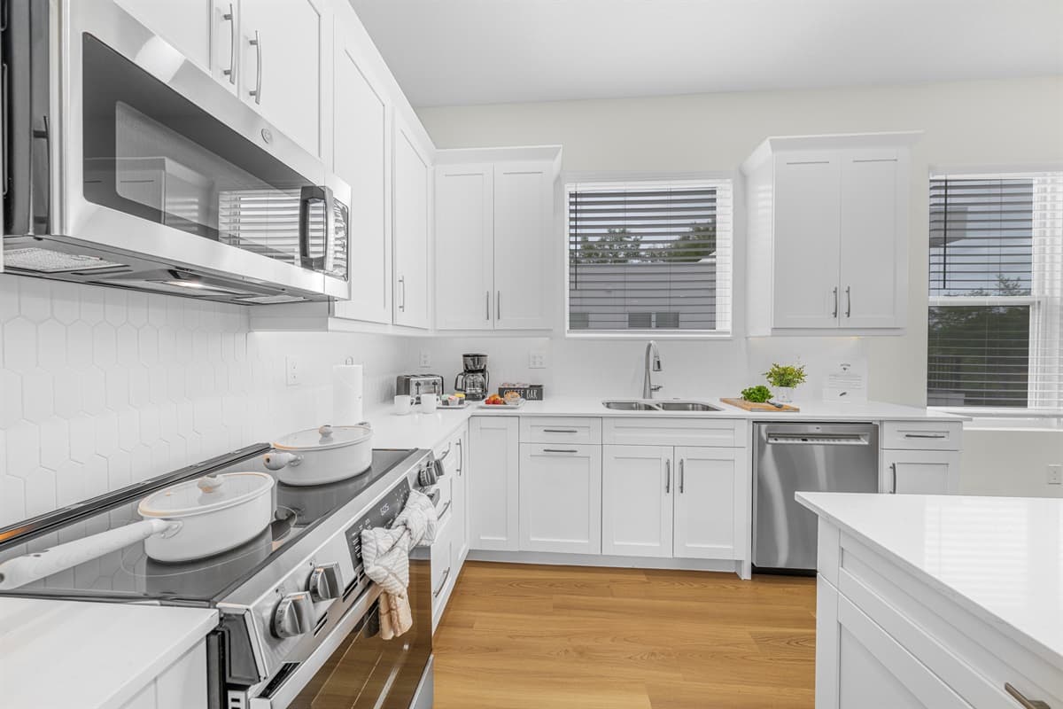 Fully equipped kitchen with modern appliances and ample cooking space.