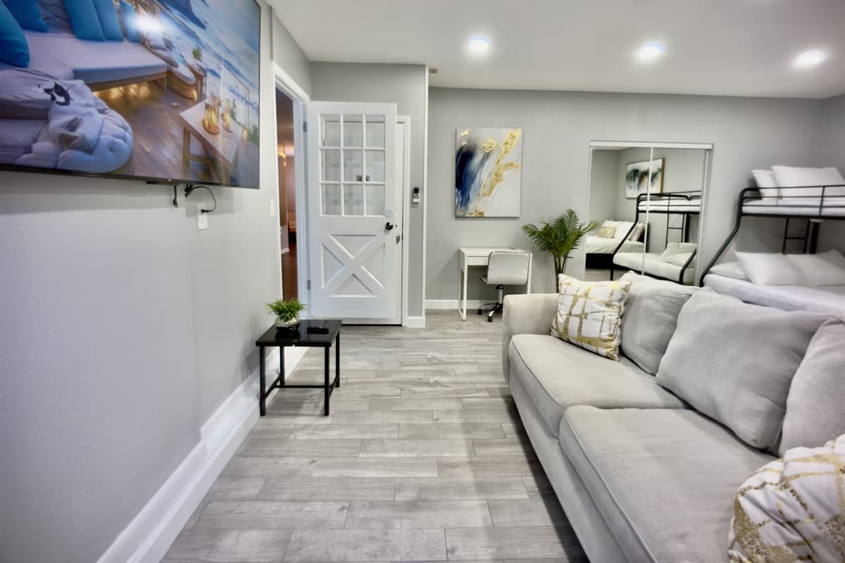 Unwind in this stylish and comfortable suite, featuring a queen-size bed, a bunk bed, and a cozy sofa, offering plenty of space to relax.