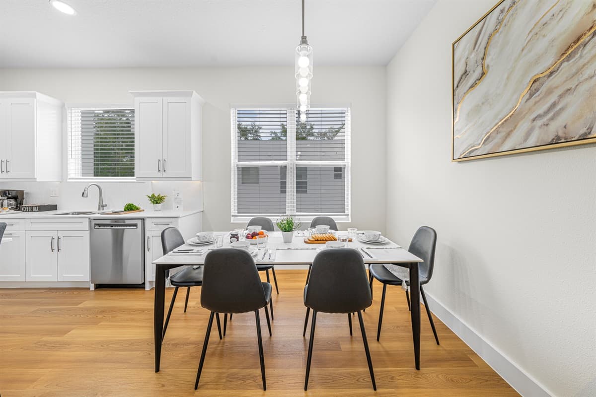 Bright dining area with modern finishes and easy access to kitchen.