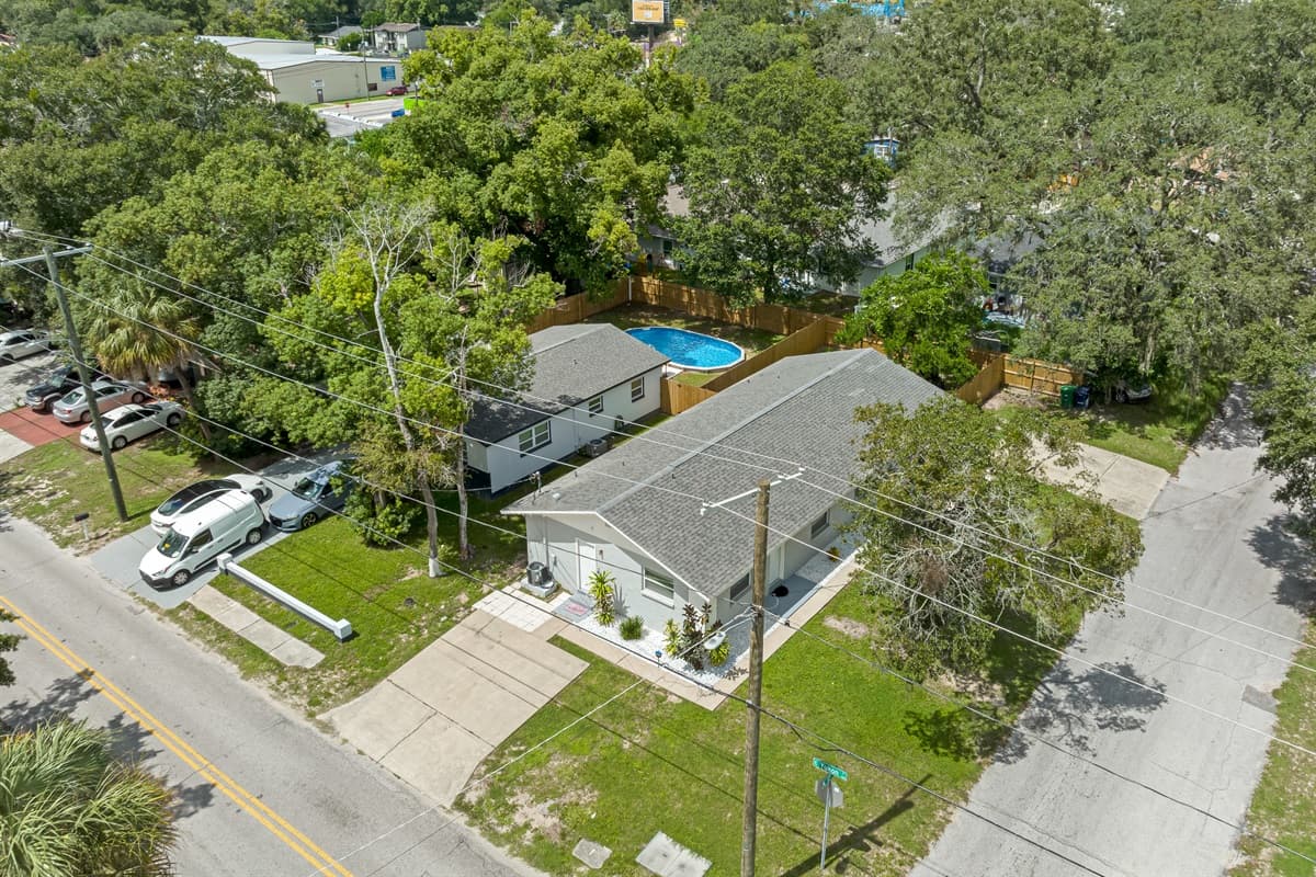 Breathtaking aerial front view of our eautiful property and the safe and wonderful neighborhood. Enjoy the view outside showcasing beautiful properties in the area. Book this property now!
