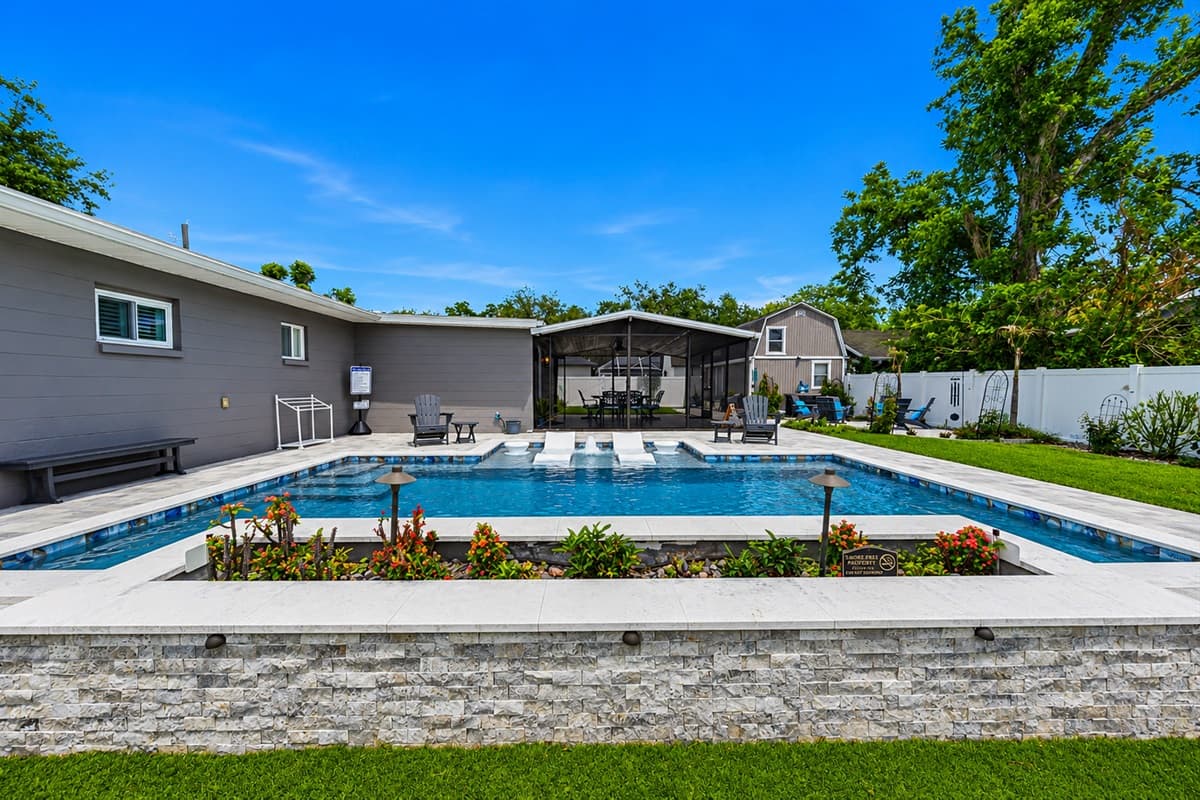 Stunning backyard view showcasing the oversized private pool and beautifully landscaped outdoor living space.