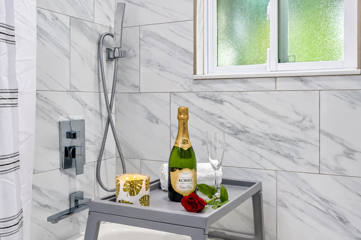 Unwind with a soak in the tub. The king suite's private bathroom has a tub and shower, modern tile, and fresh towels waiting. A relaxing end to a long beach day, without sharing the bathroom with the kids.