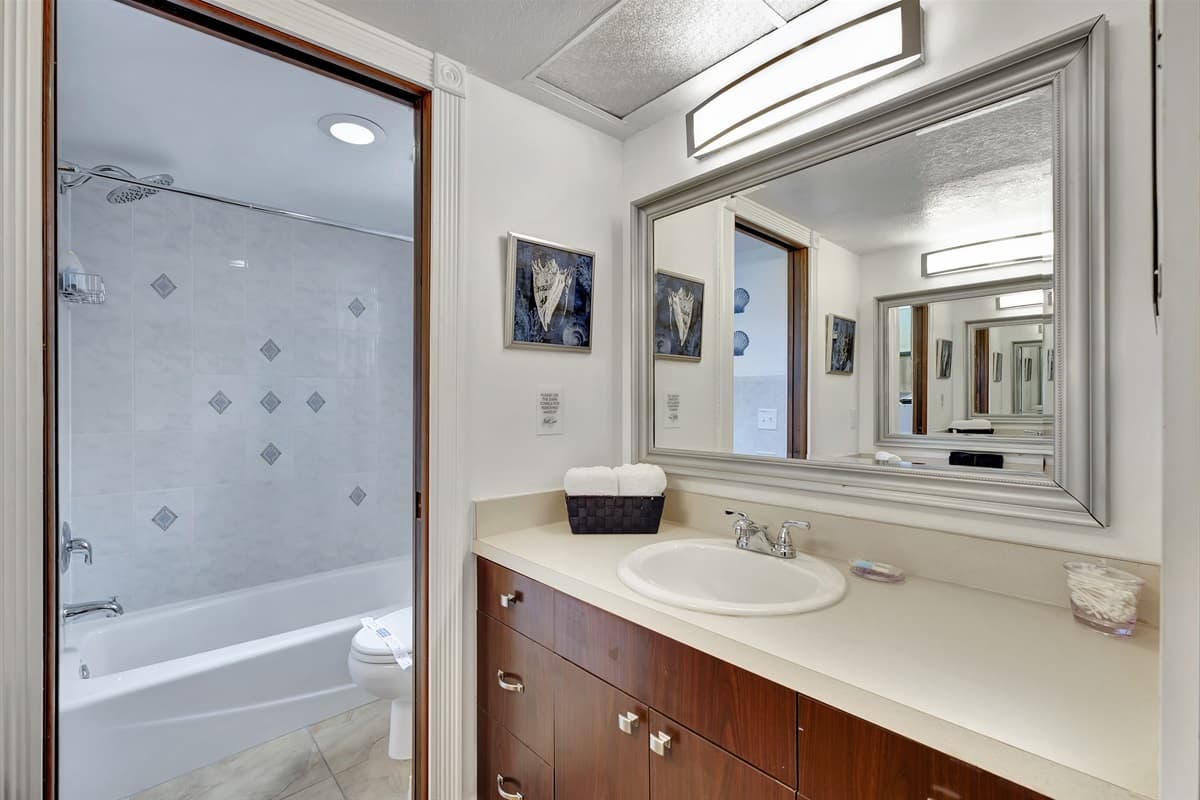 The bathroom features modern fixtures and elegant finishes, creating a spa-like atmosphere.
