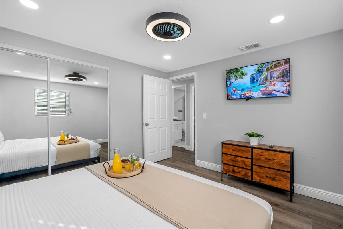 The modern furnishings, neutral palette, and cozy bedding make this room both stylish and soothing.