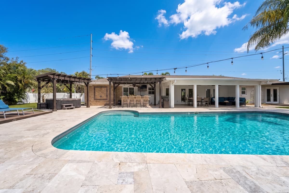 From hot tub to bar to covered lanai, this single frame shows just how much resort-style living this backyard delivers