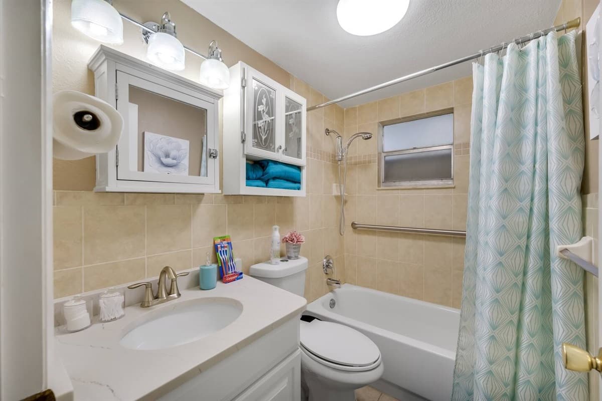 Spacious bathroom equipped with bathtub, sink, toilet and shower. Enjoy a relaxing bath after a long day of travel from your home to your home away from home. If you think this property if for you, send us an inquiry right away!