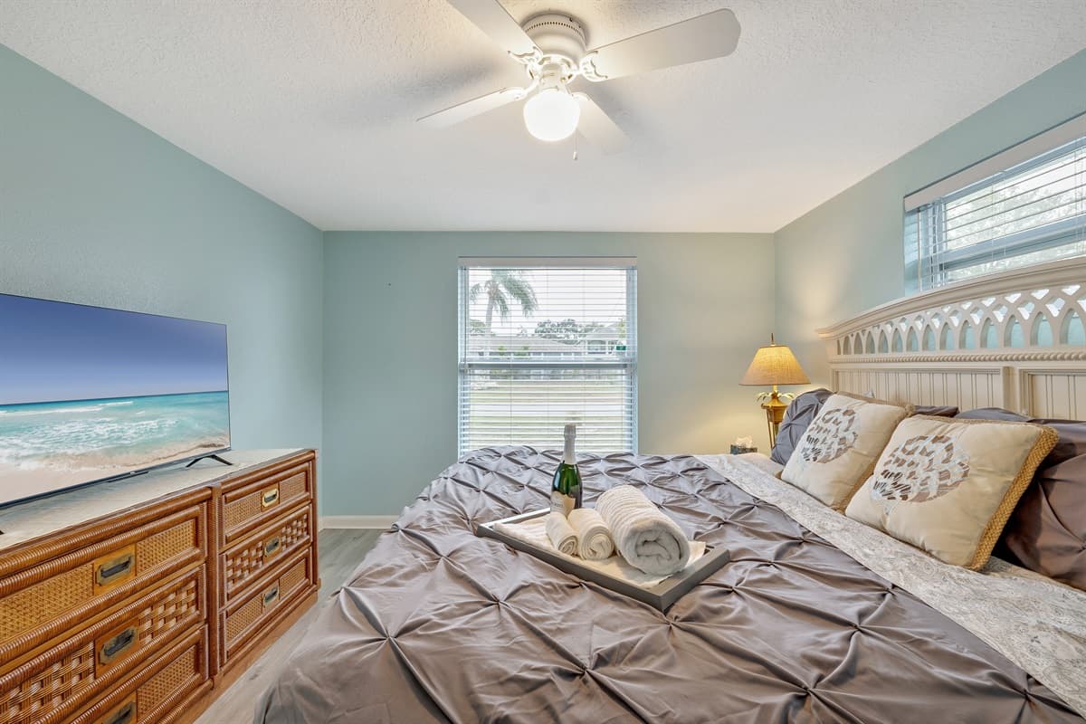 The true highlight of this room lies in its panoramic view of the waterfront canal.