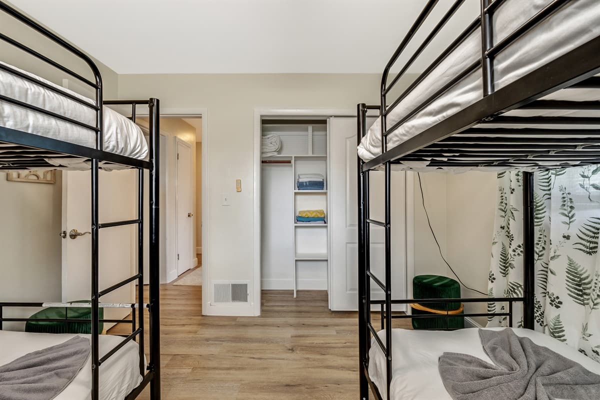 In this bedroom, versatility and thoughtful design converge to create a welcoming environment that adapts to the unique needs of each guest.