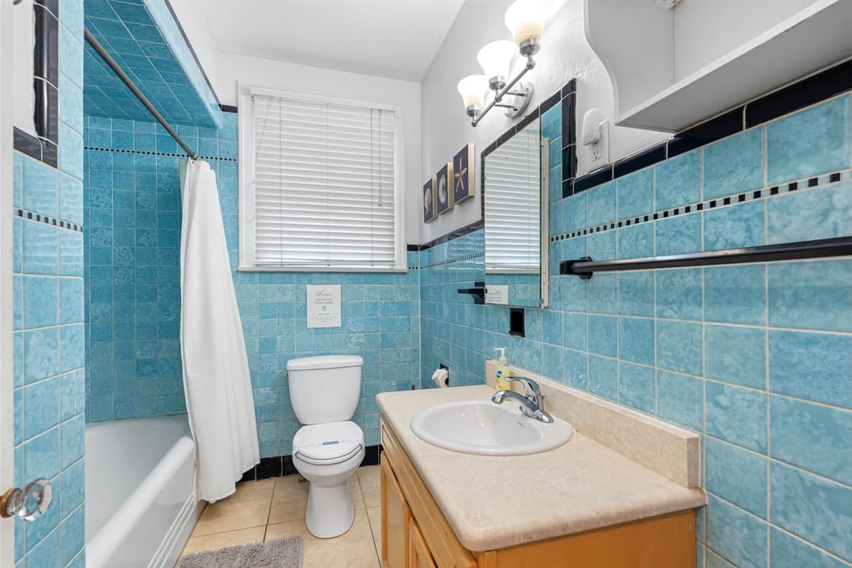 This bathroom features a sleek walk-in shower, the centerpiece of the room, which combines both functionality and style.