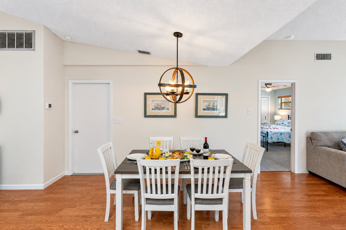 Adjacent to the kitchen is a stylish 6-seater dining table, thoughtfully chosen to complement the kitchen's aesthetic