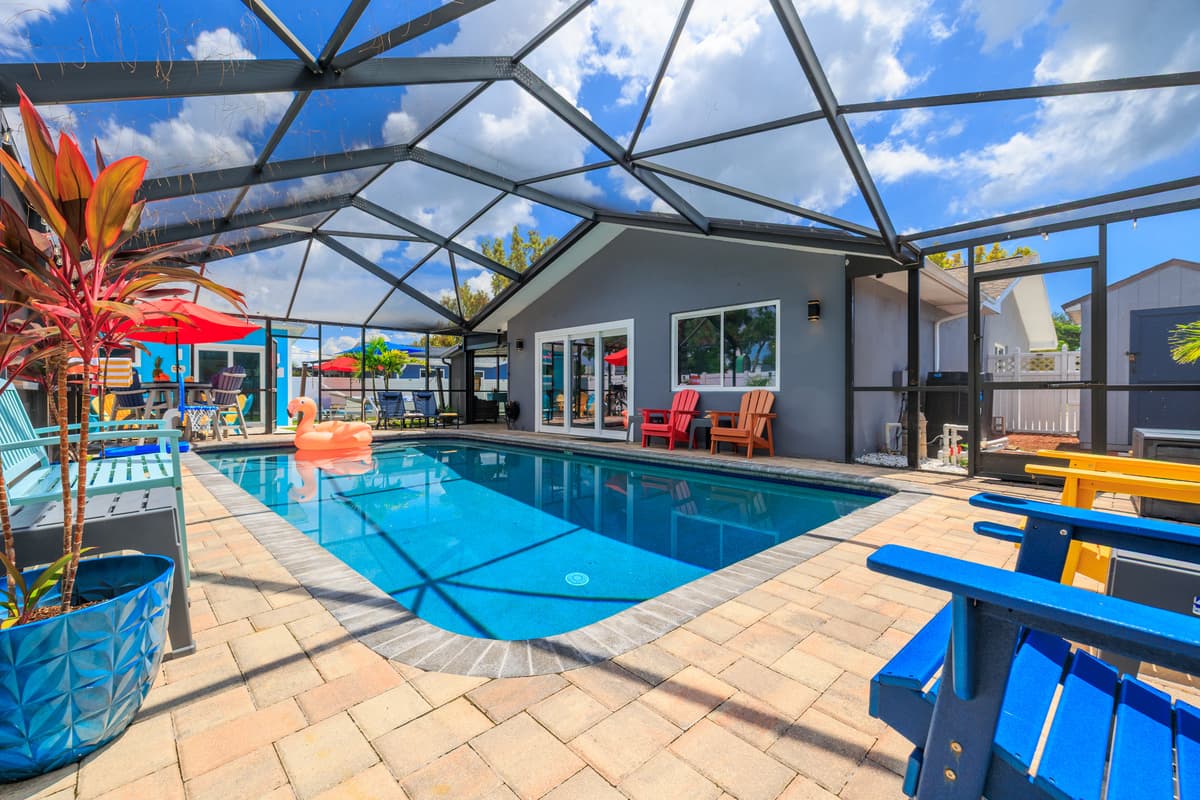 Screened-in pool and outdoor lounge space.