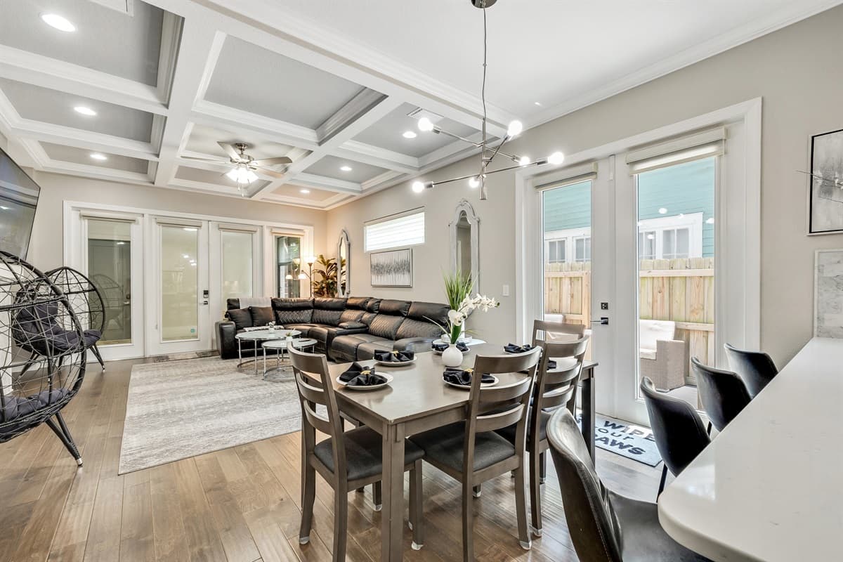 Adjacent to the dining area, the open-concept living room beckons with its plush seating and entertainment options, ensuring that even as you dine, you remain connected to the lively atmosphere of the home.