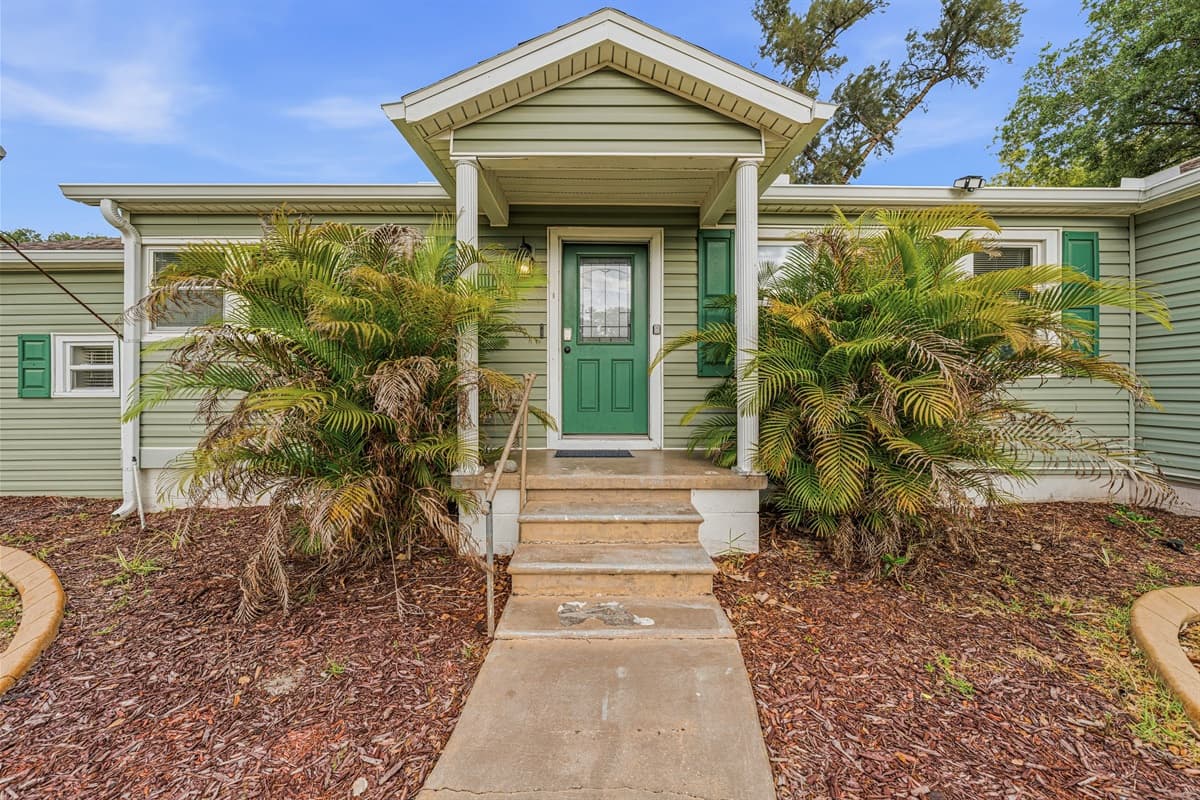 Charming front exterior with lush landscaping and inviting entryway, offering great curb appeal and a warm welcome.