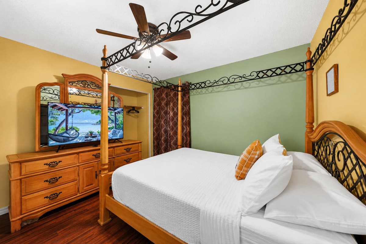 Enjoy a unique and stylish bedroom with a queen canopy bed and smart TV.